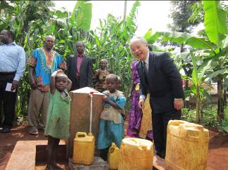 Children collecting spring water at kiosk