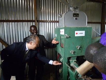 Counselor Yamazaki testing the rice mill machine